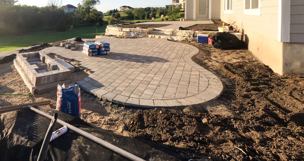 The organically shaped paver patio starting to shape up